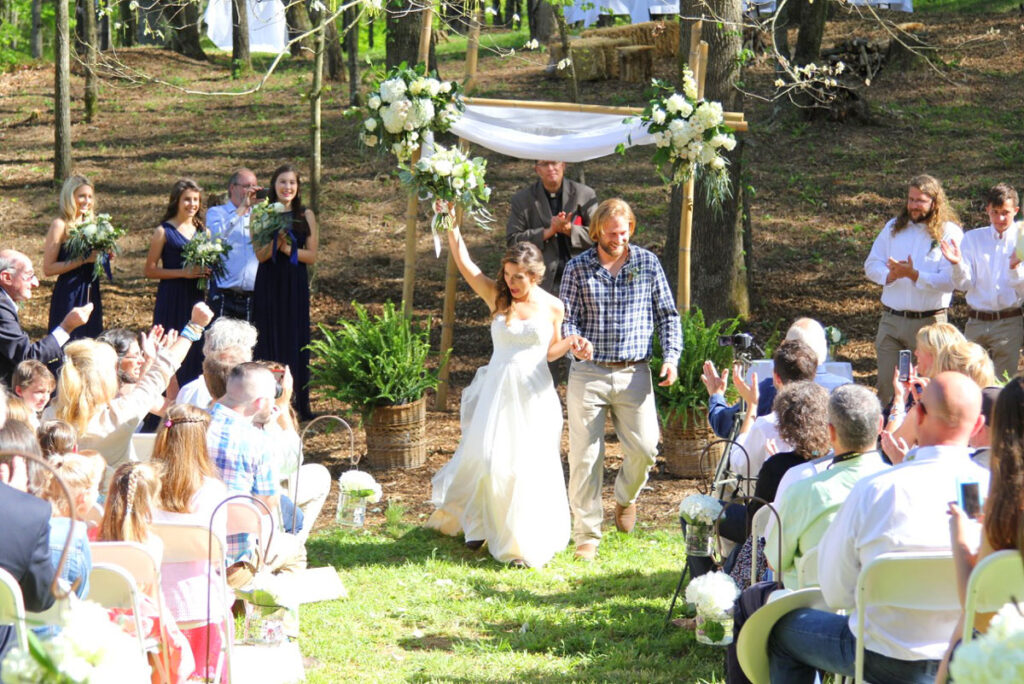Bride and groom walking down isle.